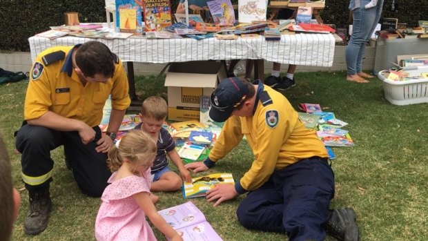 Firefighters chat to children who ran a stall to raise money for the RFS. 