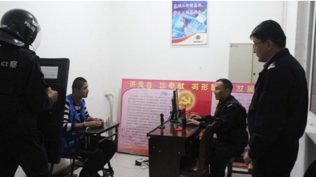 A young man is shackled in a “tiger chair” during what appears to be an interrogation in 2018.