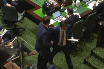Tim Smith shakes hands with Matthew Guy following question time.