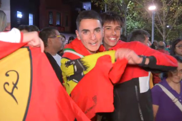 Ferrari fans celebrate in Lygon Street on Sunday night.
