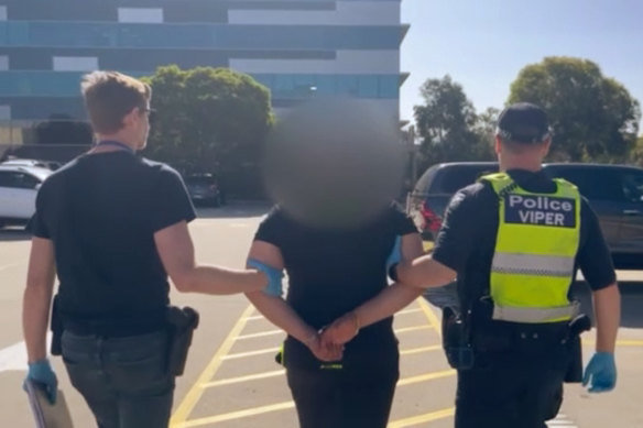 A screengrab taken from footage of police arresting on Tuesday a 25-year-old man accused of directing a series of suspicious fires across Melbourne last year.
