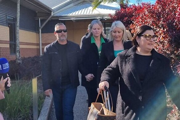 Anthony Mu and Claudean Uamaki-Mu (holding hands) leave Richlands Magistrates Court with their legal team after an earlier appearance.