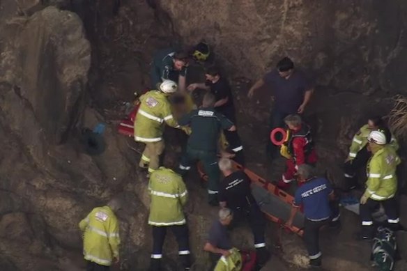 A young boy is rescued from Lesmurdie Falls on Monday.