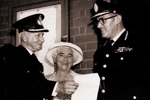 Martin, and his wife Victoria are presented with his police record by chief commissioner Selwyn Porter.