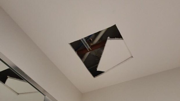 A hole cut in the ceiling of an apartment in Australia 108 as Multiplex investigates the source of cracking and creaking noises in the tower.