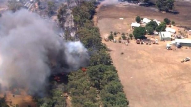 The bushfire is burning out of control in the Perth Hills suburb of Wooroloo.