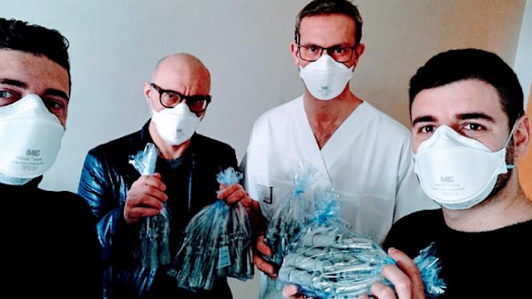 Staff of the Italian start-up Isinnova company shows valves produced with a 3D printer for hospitals near the northern Italian city of Brescia.