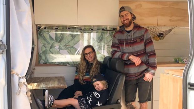 Jesse and Samantha Jeffrey and their son Bodhi in the converted campervan they share.