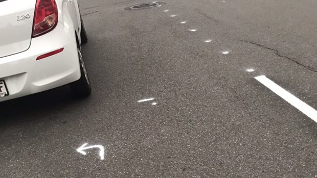 Photo taken by Ethel Chan on February 21 showing white chalk markings behind her parked car.