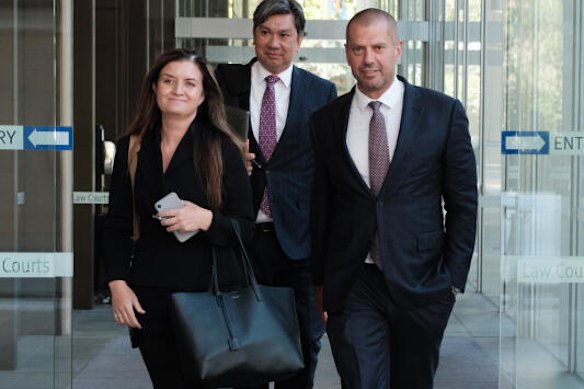 Public relations adviser Mark Hawthorne (rear) leaving court with Tolga Kumova (right) and Gilbert & Tobin solicitor Rebecca Dunn at a separate defamation trial.