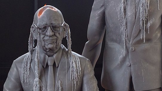 The lifelike wax figures of the two men slowly melting.