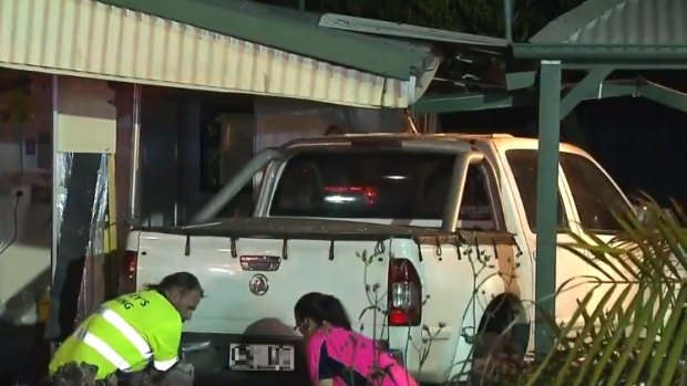 The scene in Redbank Plains after a ute crashed into a house.