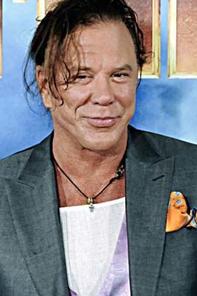 Mickey Rourke poses for photographers while promoting "Iron Man 2".