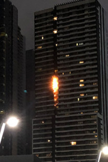 A fire fuelled by flammable cladding races up the side of Spencer Street's Neo200 tower in February. SOURCE: 3AW