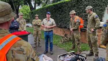Defence personnel, shown with Brisbane Lord Mayor Adrian Schrinner, helped with the clean-up.