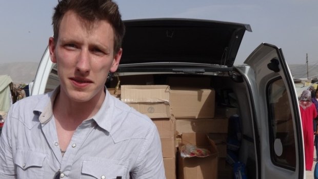 Peter Kassig standing in front of a truck filled with supplies for Syrian refugees. Islamic State militants later beheaded him. 