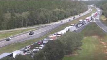 bruce highway northbound traffic closes caravan rollover lanes delays after facing mountains camera shows glass through south house reopens queensland