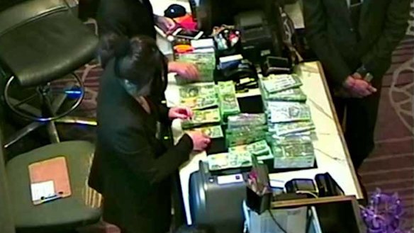 The NSW government inquiry has examined footage leaked to MP Andrew Wilkie showing large amounts of cash being exchanged in one of Crown Melbourne's private gaming rooms.