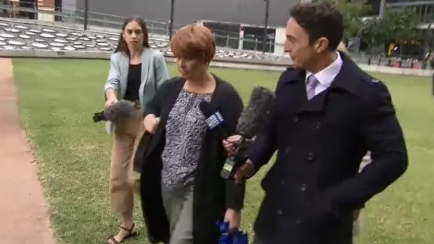 Julene Thorburn leaves a Brisbane court in disguise on Tuesday, donning a fake red wig and a change of clothes after testifying to the Tiahleigh Palmer coronial inquest.