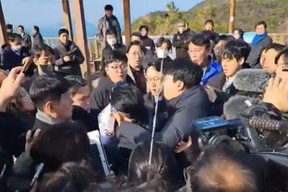 The crowd reacts after South Korean opposition party chief Lee Jae-myung was stabbed in the neck.