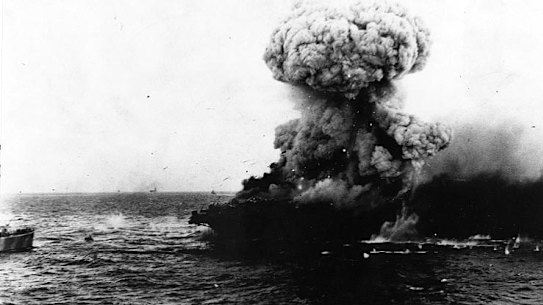 A mushroom cloud rises after a heavy explosion on board USS Lexington, 8 May 1942.