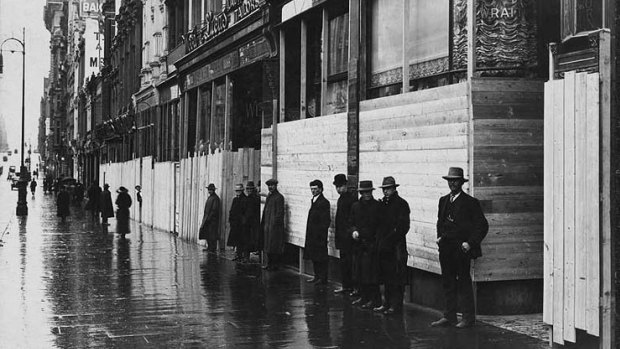 Two-metre tall wooden barricades protect the ornate buildings on Collins Street during the strike.