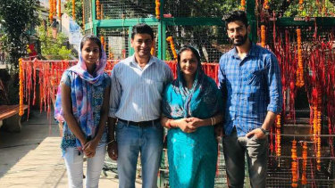 Australian permanent resident Pragya Chandel (second from left), his wife and two adult children were knocked back from the first repatriation flight out of Delhi after three of the four family members tested positive.