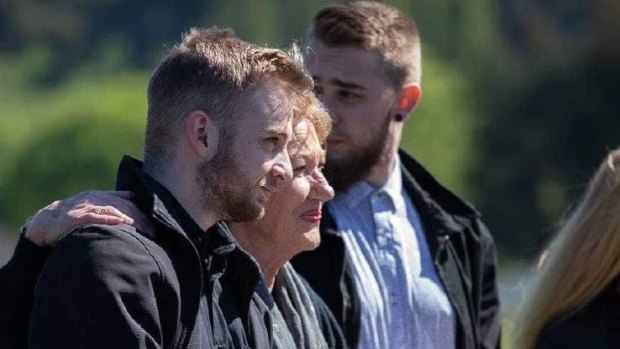 Ian Pullen's sons Cody and Troy carry their father's ashes, with Mr Pullen's mother Gill.