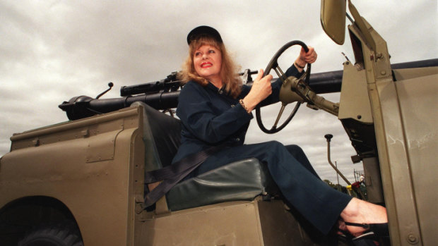 At the Australian War Memorial, singer Little Pattie arrives in a jeep of the kind used during the Vietnam War. 