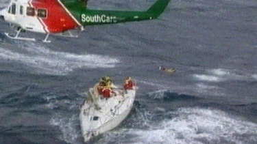 Flashback The 1998 Sydney To Hobart Yacht Race Tragedy - a rescue helicopter hovers over a damaged yacht off the coast of new south wales