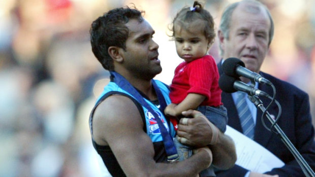 Byron Pickett and daughter after winning the Norm Smith Medal in 2004. 