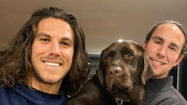 Callum and Jake Robinson with their dog.