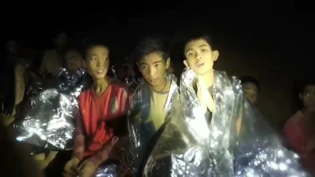 A video taken by Thai Navy SEALs shows the boys in the cave with their space blankets. 