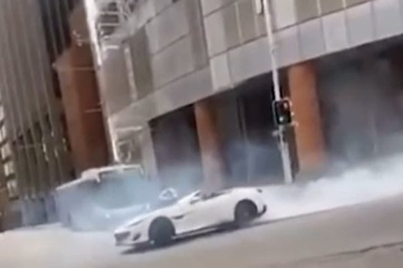 The 2019 Ferrari Portofino conducting burnouts in the intersection, resulting in smoke and blocked traffic.