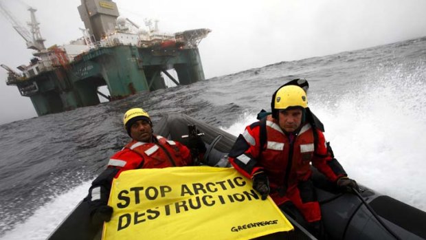 Greenpeace activists prepare to scale an oil rig off the coast of Greenland.