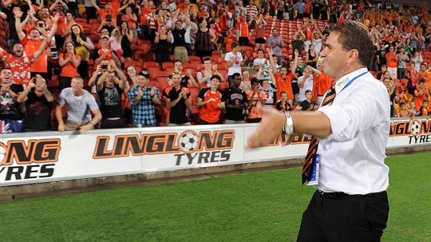 Ange Postecoglou performs a victory lap of Suncorp Stadium after the Roar's 36th unbeaten game in a row.