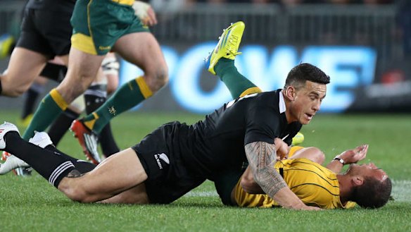 All Blacks Sonny Bill Williams tackles Quade Cooper at Eden Park.
