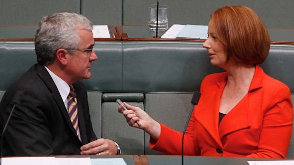 Wilkie talks with then-prime minister Julia Gillard in parliament.