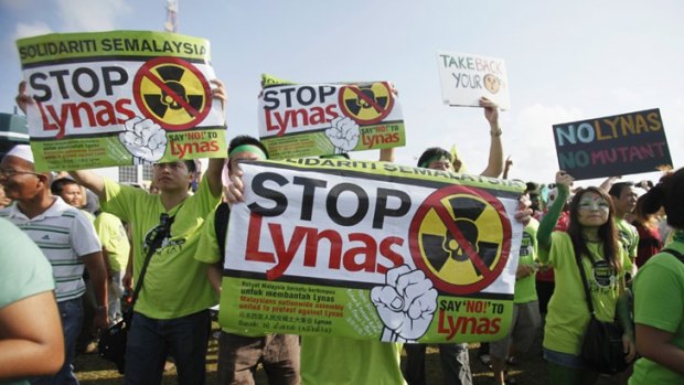Residents display placards to protest against the construction of the Lynas earth plant in Malaysia's town of Kuantan.