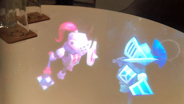 Knights battle on a table, as seen through the Magic Leap One.