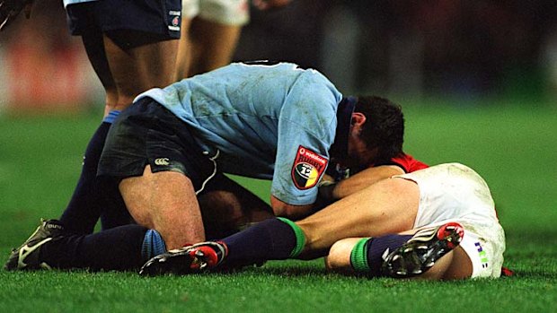 The Waradahs' Duncan Mcrae punches Ronan O'Gara of the lions in 2001.