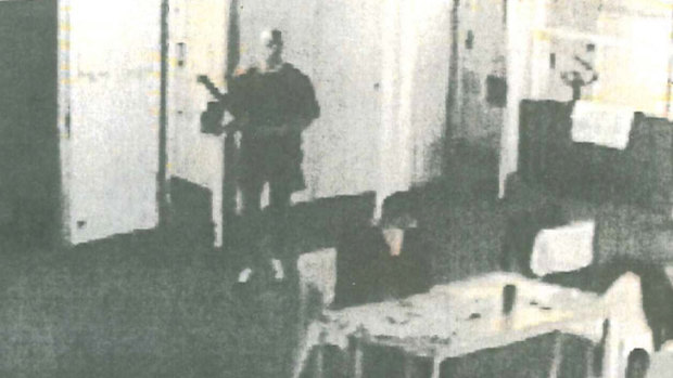 CCTV footage from shortly before Carl Williams (seated) was beaten to death by Matthew Johnson inside prison in April 2010.