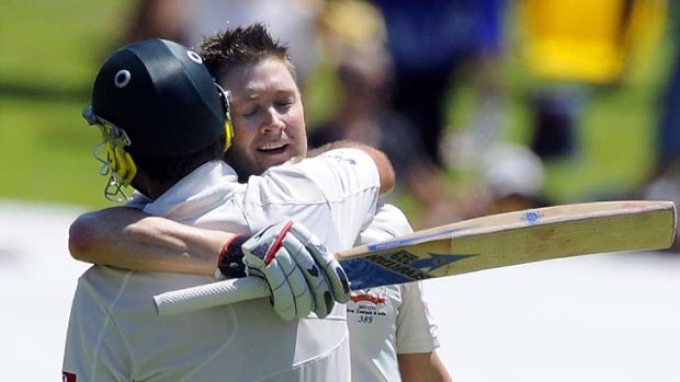 Michael Clarke (right) celebrates scoring a double hundred with his new sponsor's bat in Adelaide.