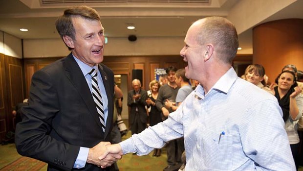 Cr Quirk shakes hands with his mayoral predecessor, Campbell Newman.