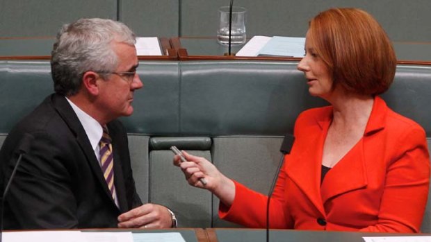 Wilkie talks with then-prime minister Julia Gillard in parliament.