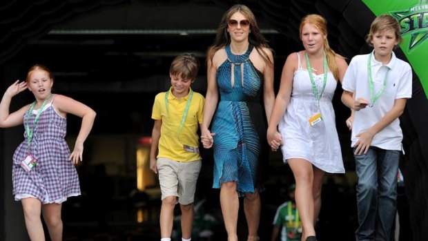 Hurley with her son Damien (in yellow) and Warne's children (L-R) Summer, Brooke and Jackson at the MCG in Melbourne in December 2011.
