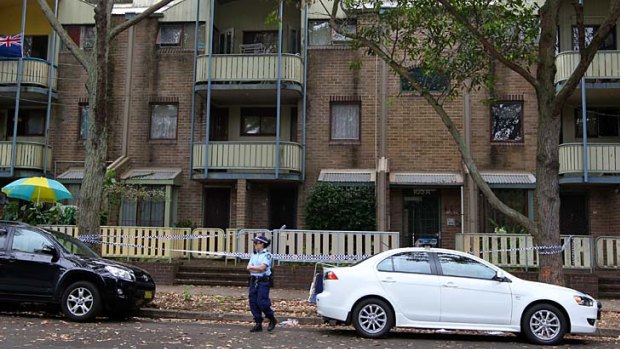 Police at a unit block on Walker Street, Waterloo, after Mr Scarman's body was found.