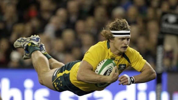 Cummins scores a try against Ireland during the Rugby International in Dublin in 2013. 