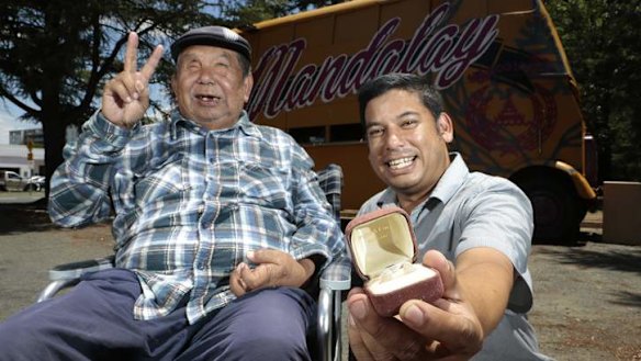 Mandalay Bus owners George Thaung and his son Stewart with a pair of opals given to them by a former homeless man, who had been helped by George before finding the gems at Lightning Ridge.