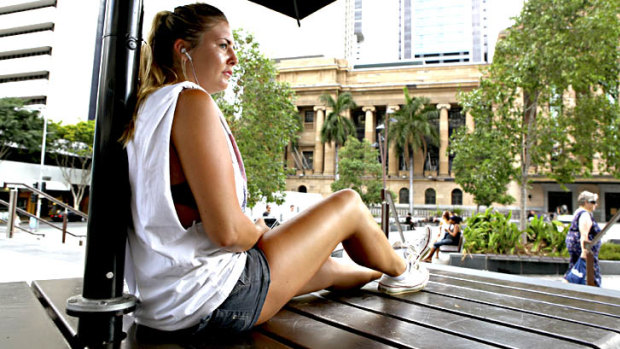 FILE IMAGE: English backpacker Holly Marsh, 20, relaxes in the King George Square shade on a sticky Brisbane day.